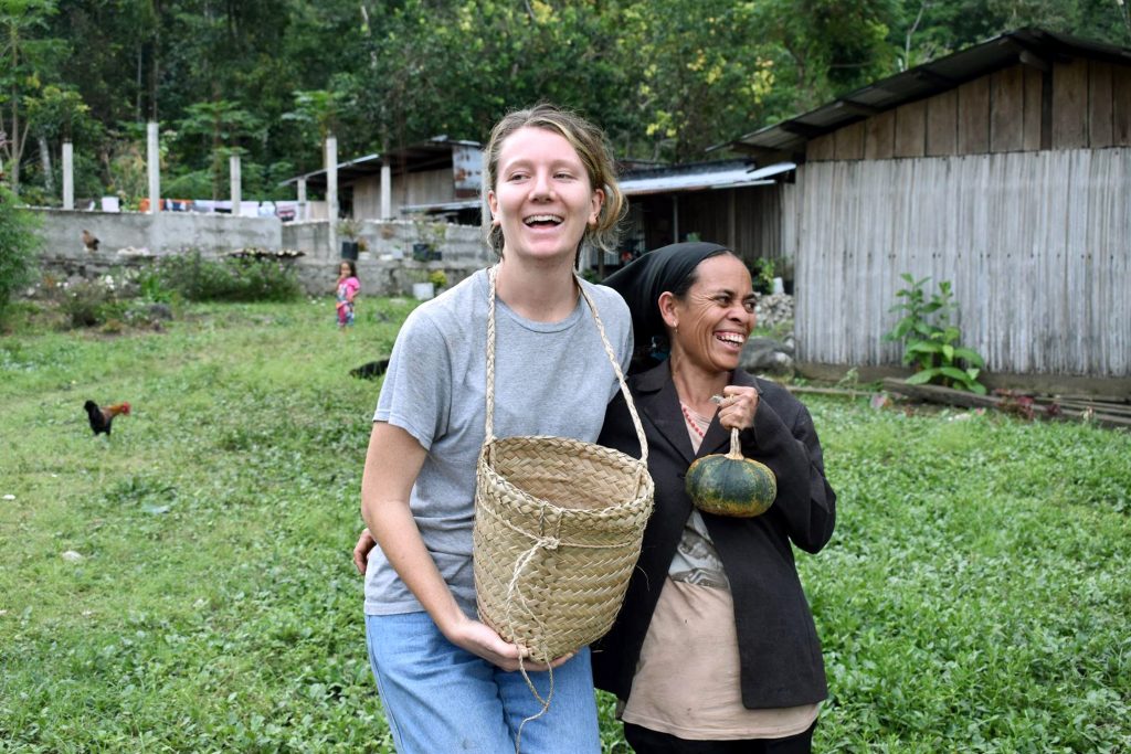 Phoebe Whittington collects coffee beans with locals in the town of Same. Photo: Supplied