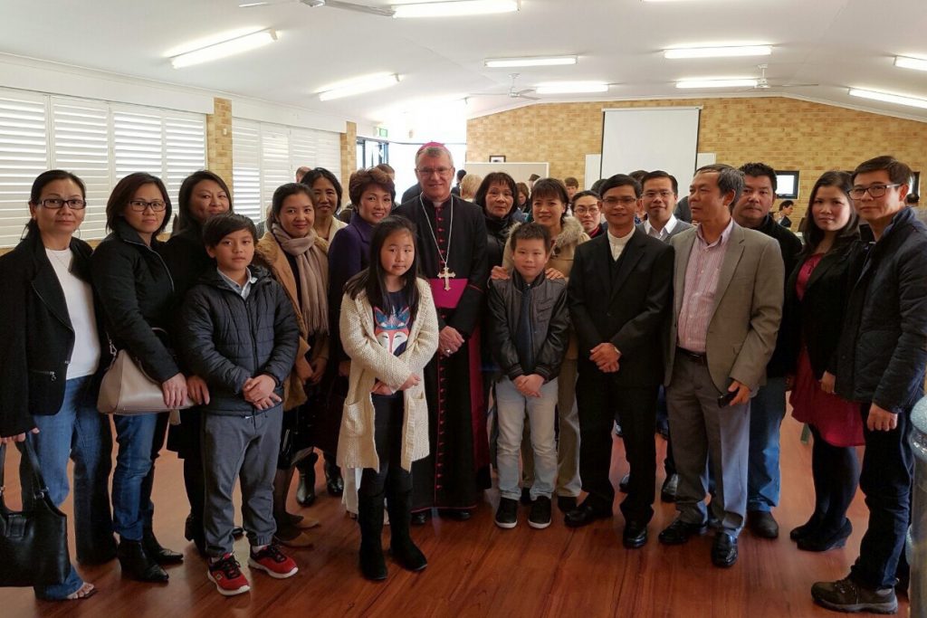 Archbishop Timothy Costelloe SDB and Father Michael Quynh Do, pictured with Cloverdale parishioners, after the Installation Mass at the Church of Notre Dame. Photo: Supplied