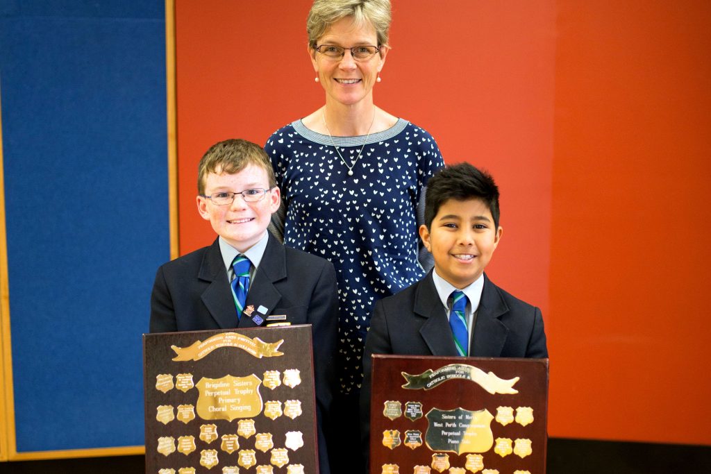 Trinity College Junior School Music Teacher Mrs Ann Clarke and Junior school students with shields that they won. Photo: Supplied