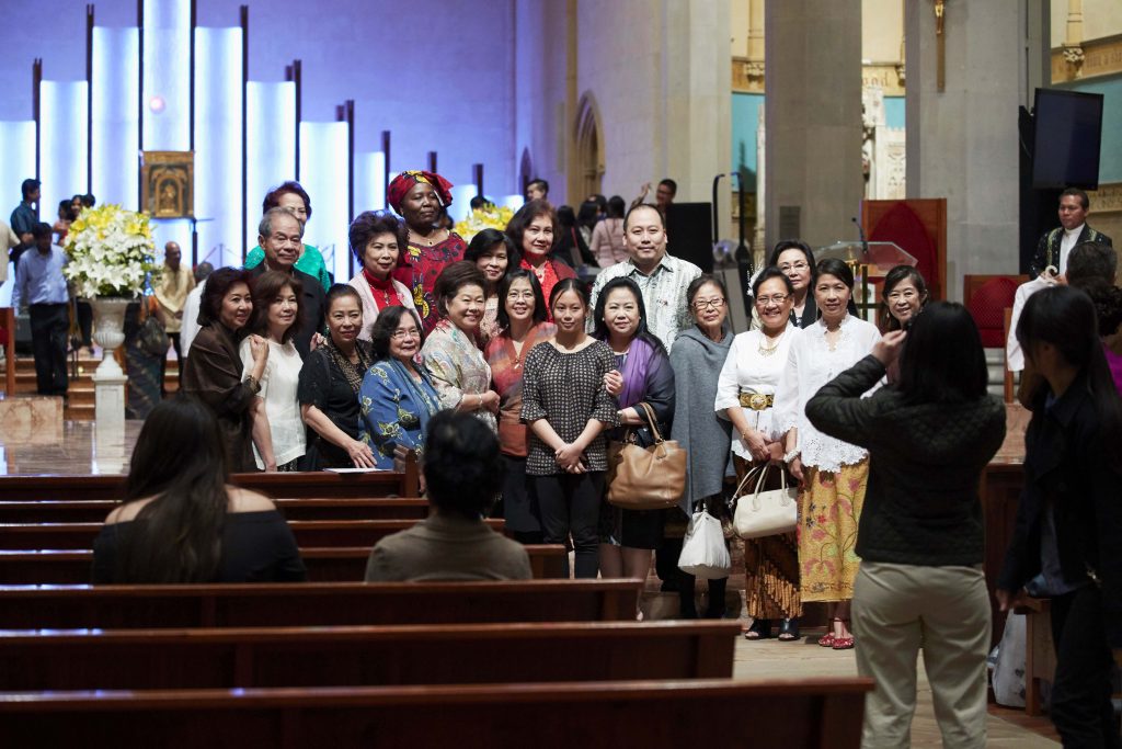 Parishioners, many of whom wore their national dress for the occasion, pose for photos in St Mary’s Cathedral following the Mass. Photo: Ron Tan