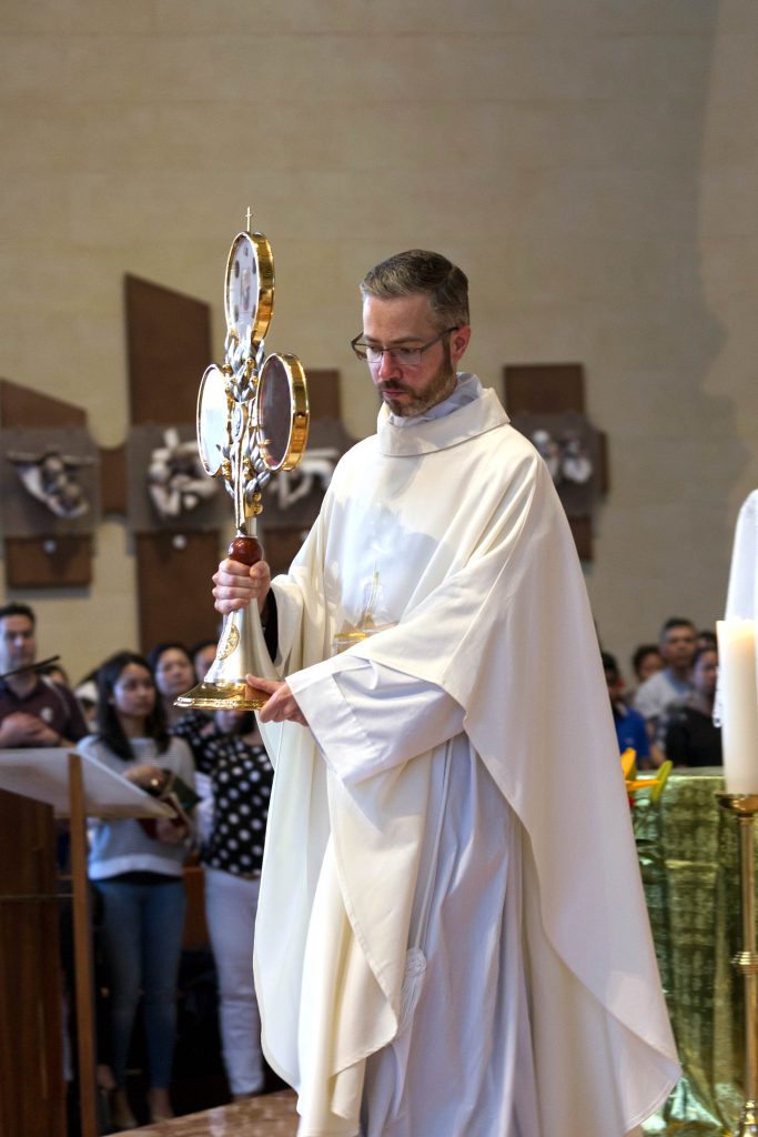 Assistant Priest at St Mary’s Cathedral, Father Conor Steadman, holds the relics of St Pio of Pietralcina at a Mass held on 22 October 2016. Photo: Ron Tan