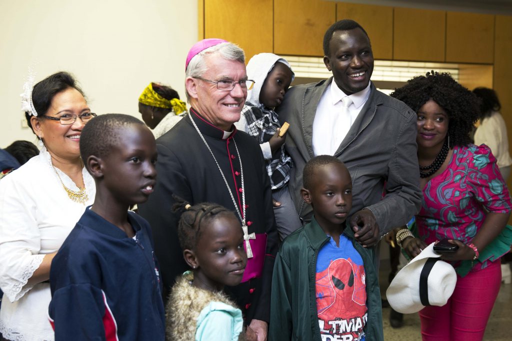 Archbishop Costelloe joined guests for refreshments after the Multicultural Mass. He is pictured here with an African family. Photo: Ron Tan