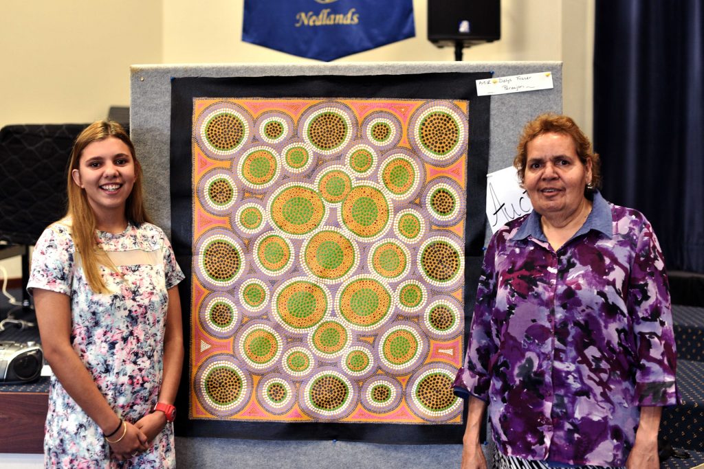 Tamara Gamble (left) has recently graduated from Nagle Catholic College in Geraldton after being sponsored by the Good Samaritan Sisters’ Rural Outreach Program. She is pictured with Perenjori artist Delys Fraser, who donated a painting to raise funds for the program. Photo: Frank Lincoln