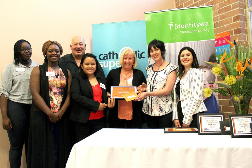 Christine Camacho from Catholic Super presenting the ‘Ganges Team’ - staff who support individuals living in one of Identitywa’s shared homes. Photo: Supplied