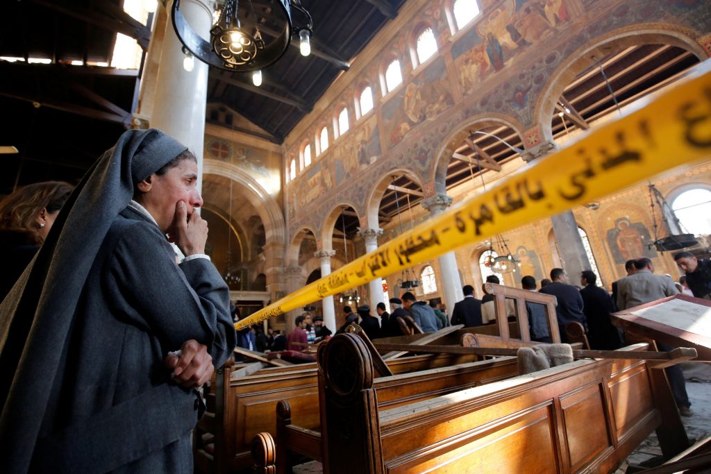 A nun cries as she stands inside St Mark's Coptic Orthodox Cathedral on 11 December after an explosion inside the cathedral complex in Cairo. A bomb ripped through the complex, killing at least 25 people and wounding dozens, mostly women and children. Photo: CNS/Amr Abdallah Dalsh, Reuters