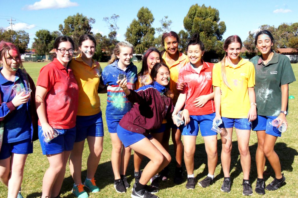 John Paul College students celebrate after participating in the colour run stall at their Founders Day Fair earlier this year. The school’s fundraising efforts and active participation in LifeLink Day has seen them named as recipients of the 2015 Archbishop’s Spirit Award. Photo: Supplied