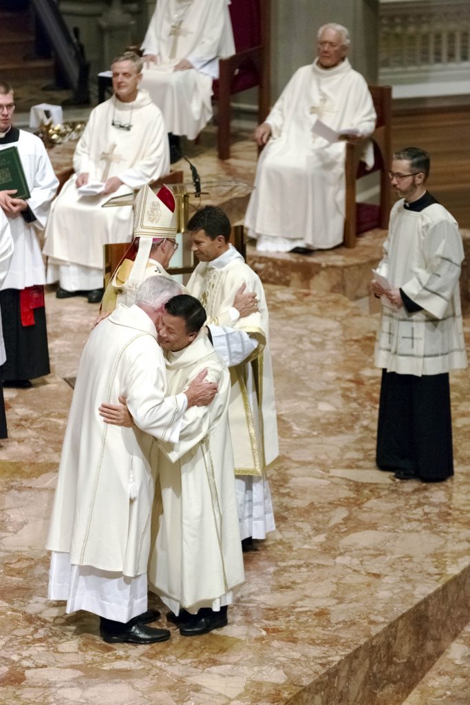 The newly ordained deacons embrace fellow priests from the Archdiocese during their ordination to the diaconate on Friday 2 December, 2016 at St Mary’s Cathedral. Photo: Ron Tan