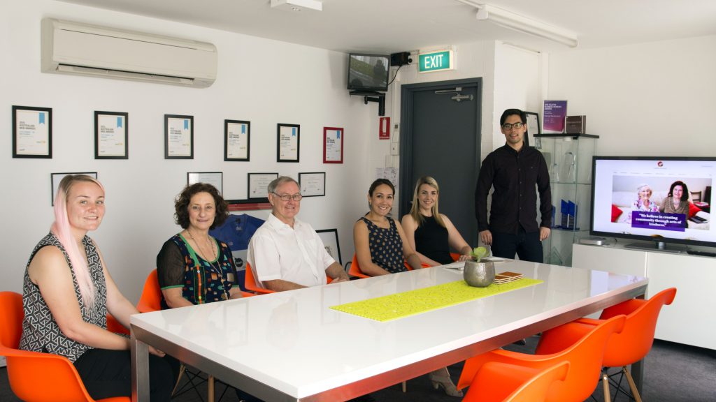 Catholic Outreach Director Peter McMinn and Officer Betty Thompson (third and second from left) with Bam Creative staff Teegan Lincoln, Patima Tantiprasut, Jessica Kaitse and David Lim. Photo: Caroline Smith