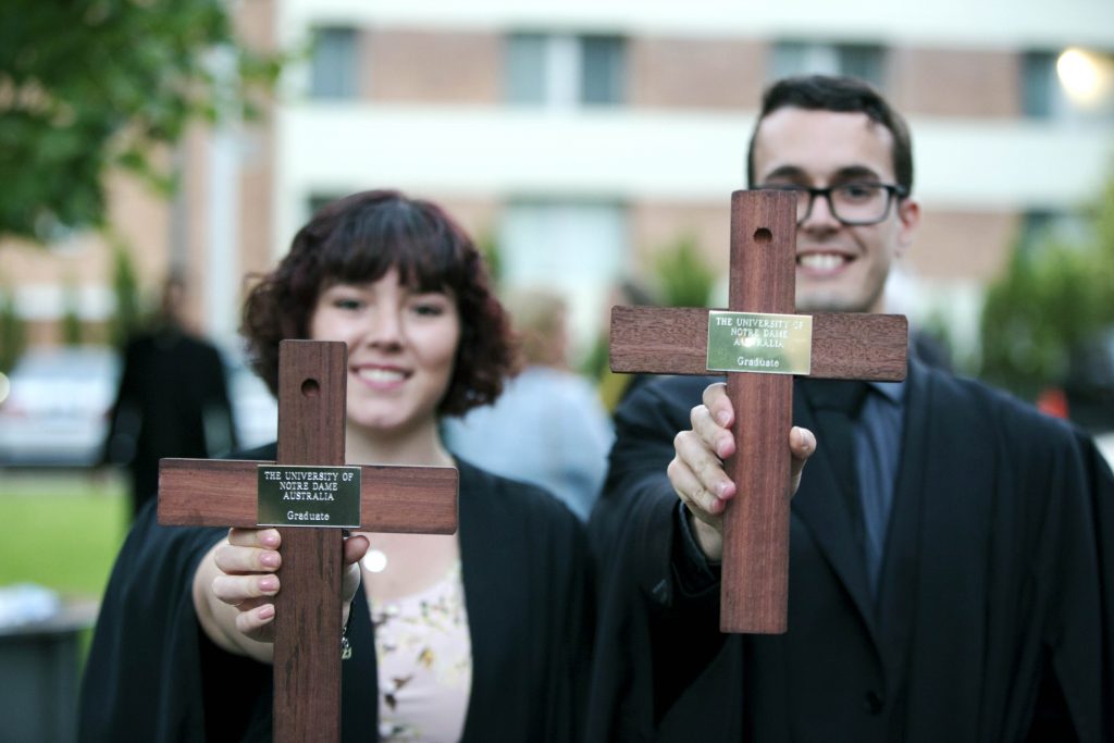 Proud graduates display their Notre Dame graduation crosses. Photo: Ron Tan