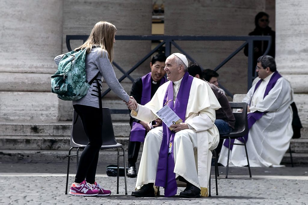 Pope Francis welcomes a young pilgrim before hearing confession April 23 in St. Peter's Square at the Vatican. Youth from around the world flocked to Rome for a special Year of Mercy event for teens ages 13-16. Photo: CNS photo/Angelo Carconi, EPA