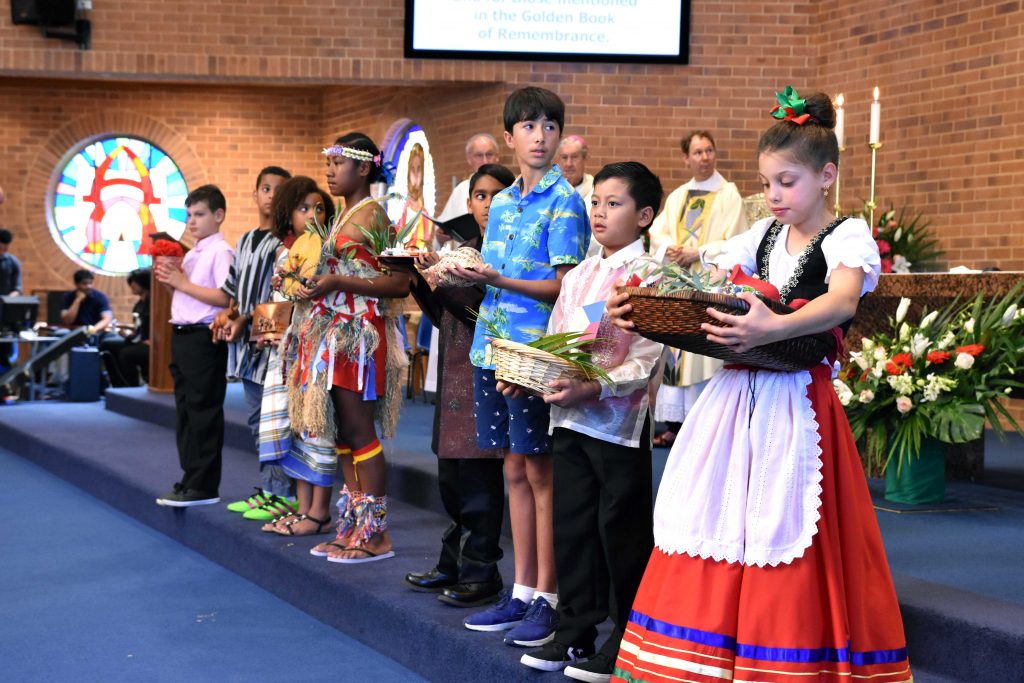 Children dressed in national wear offering up gifts from around the world representing peace, hope, joy and love. Photo: Natashya Fernandez