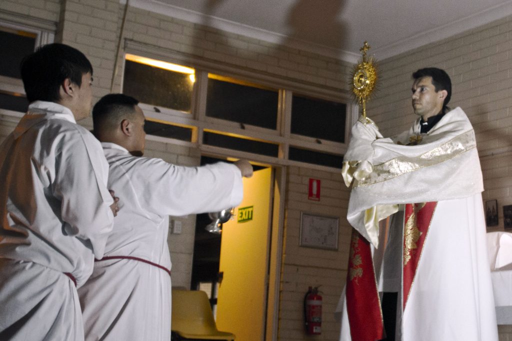 Newly-ordained Deacon Mariusz Grzech officiates the Eucharistic Adoration and Benediction during the Embrace the Grace conference, held from 7-11 December in New Norcia. Photo: CYM Perth