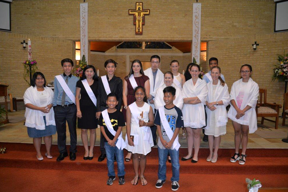 Morley parishioner Kylie Farina (second from right, second row), celebrates her entry into the Catholic Church along with other people receiving sacraments. Photo: Supplied