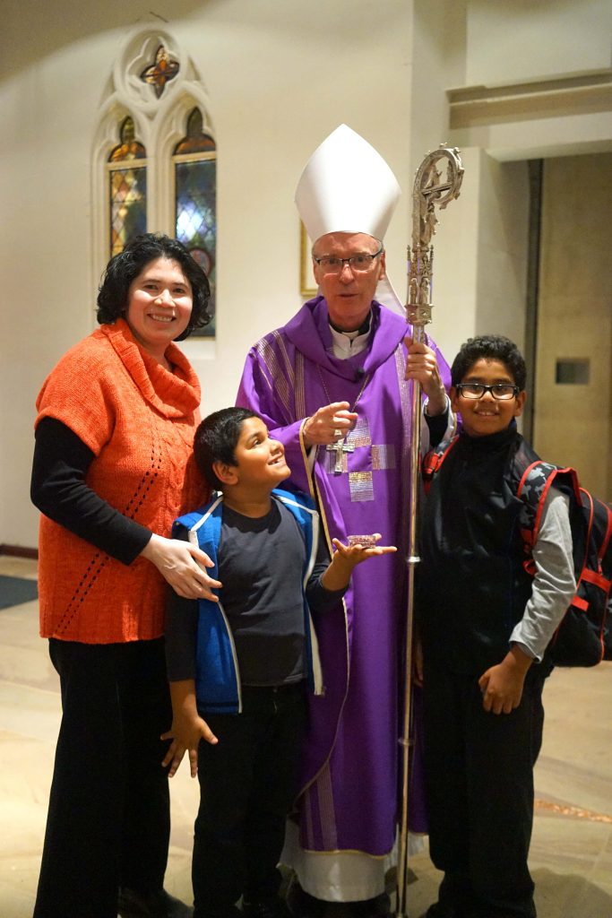 Perth Auxiliary Bishop Donald Sproxton with Merle Furtado and her children Gareth and Garren at the Focolare event on 18 March. Photo: Supplied