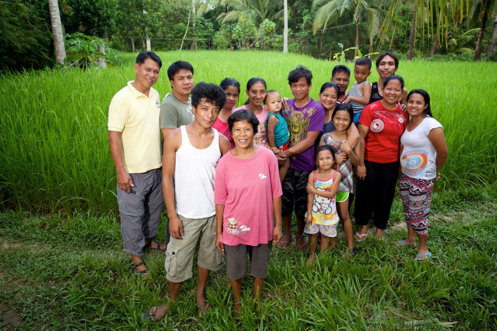 Dinia and her son Lydon (21) with her family, community members and SPACFI staff. Photo: Richard Wainwright/Caritas Australia