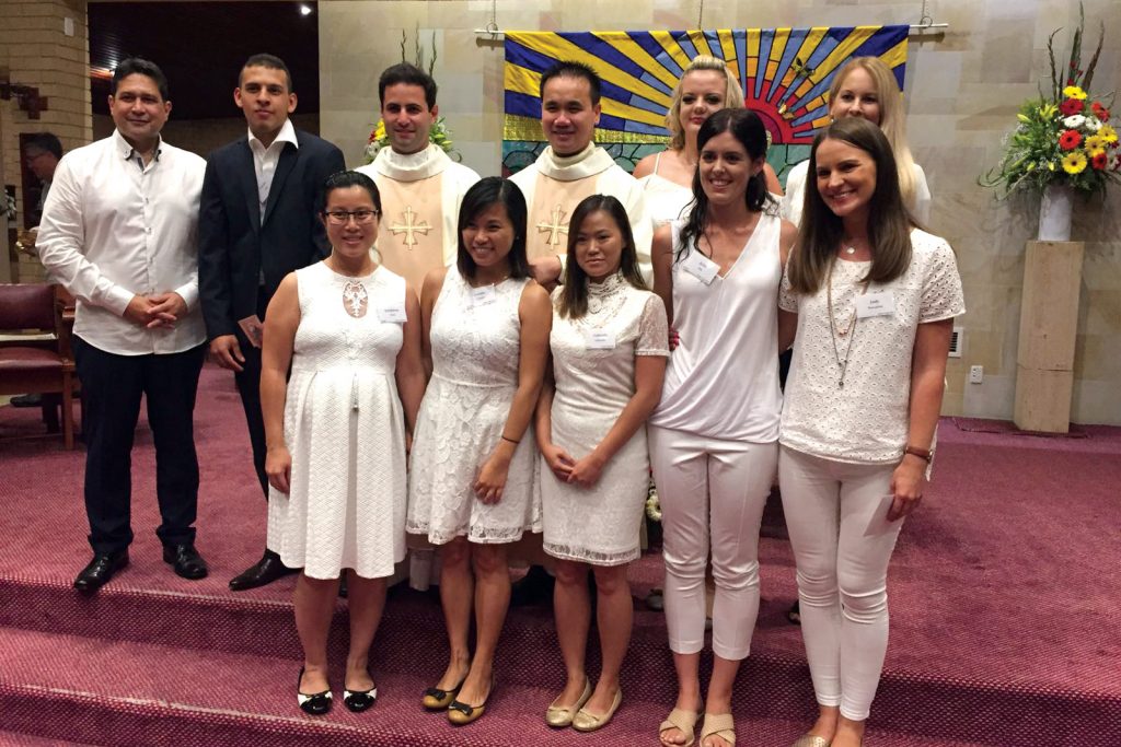Catechumens and Candidates with their sponsors and the rest of the RCIA team at the Baptism