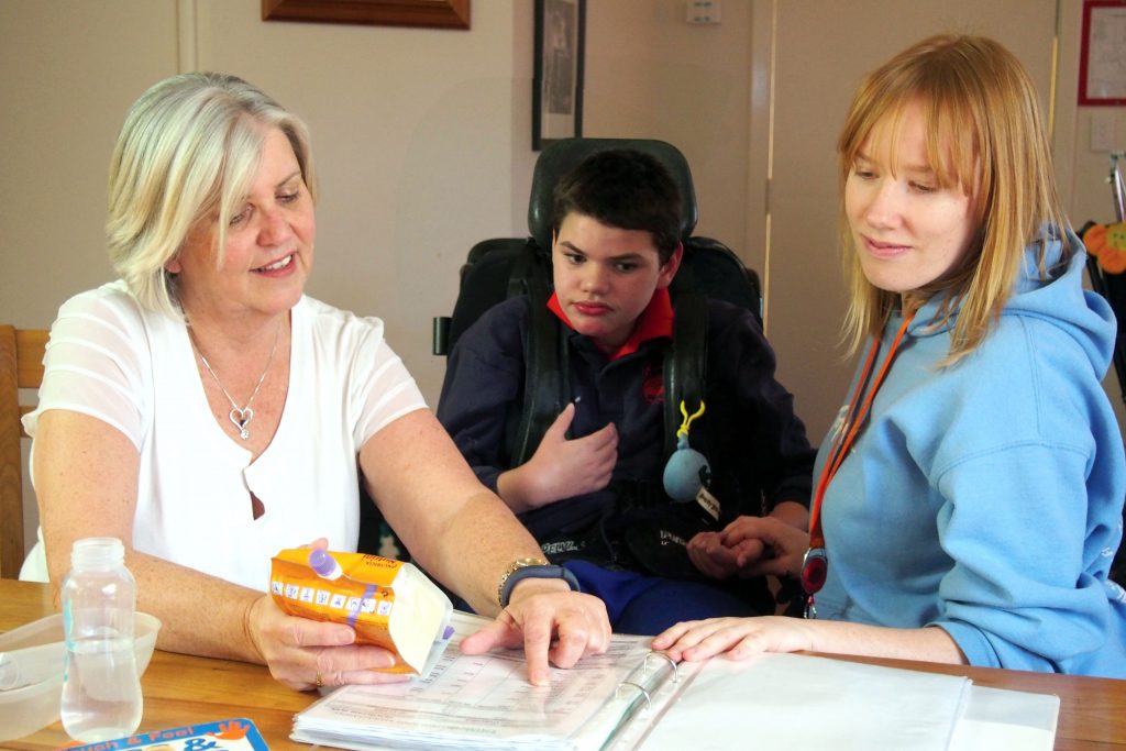 John accesses support at Identitywa’s Nollamara children’s home. Clinical Nurse, Kerry Deakin, is updating his health care plan with Support Worker, Maddy. Photo: Supplied