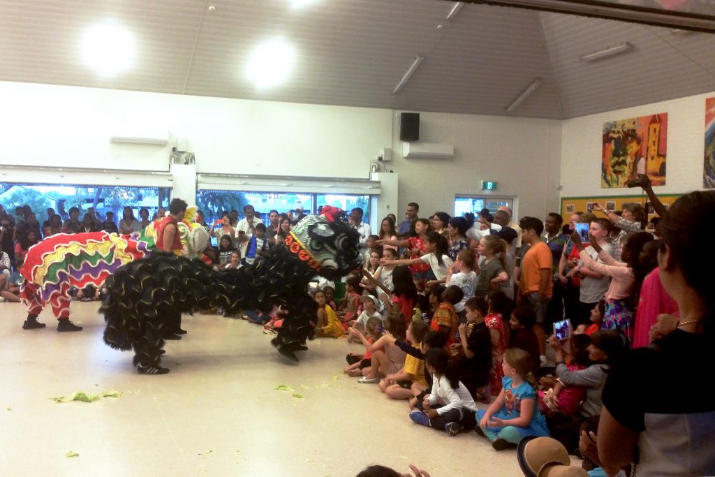 Students and their families enjoying the Chinese Dragon Dance as part of the festivities of the day. Photo Supplied