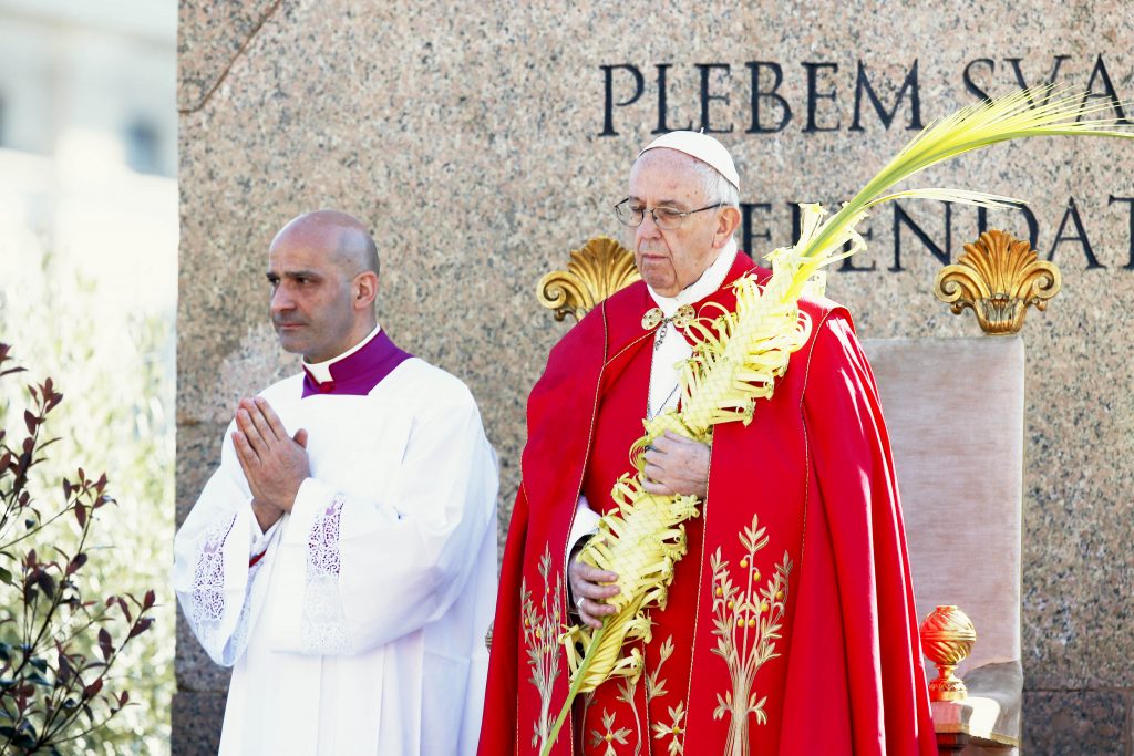 Pope Francis holds palm fronds as he celebrates Palm Sunday Mass in St Peter's Square at the Vatican on April 9. Photo: CNS/Paul Haring