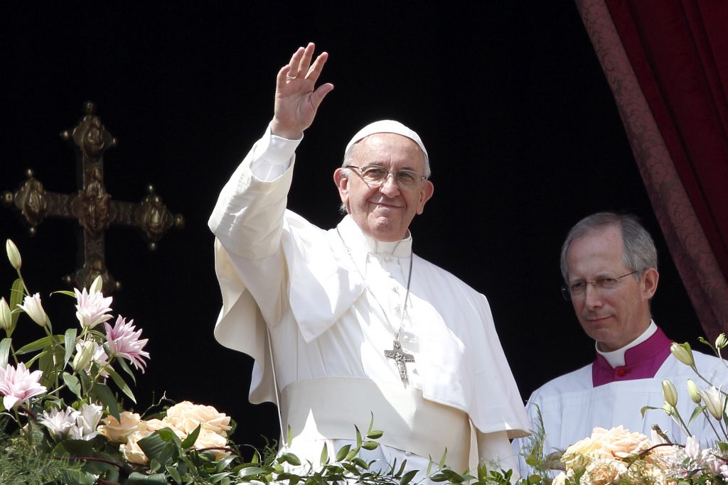 Pope Francis greets the crowd after delivering his Easter message and blessing "urbi et orbi" (to the city and the world) from the central balcony of St Peter's Basilica at the Vatican on 16 April. Photo: Paul Haring/CNS