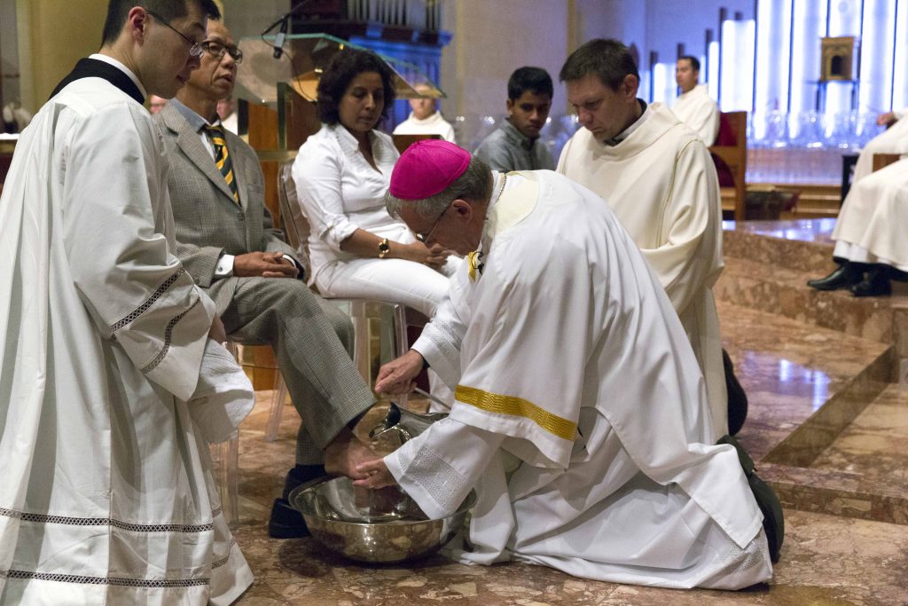 The Archbishop washing the feet of others at the Mass of the Lord’s Supper on Holy Thursday, following in the example of Jesus, representing the call to serve with humility and selflessly. Photo: Ron Tan
