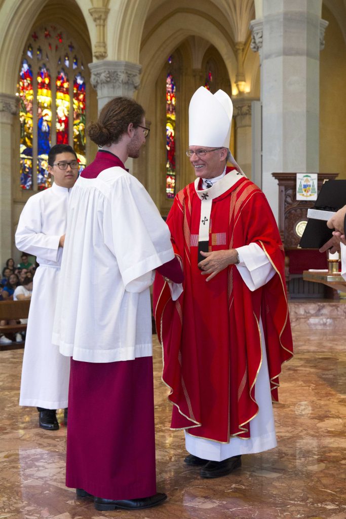 Archbishop Timothy Costelloe SDB presenting Joshua Adams with the RSCM Gold Award at the Palm Sunday Mass held at St Mary’s Cathedral, Sunday 9 April. Photo Ron Tan
