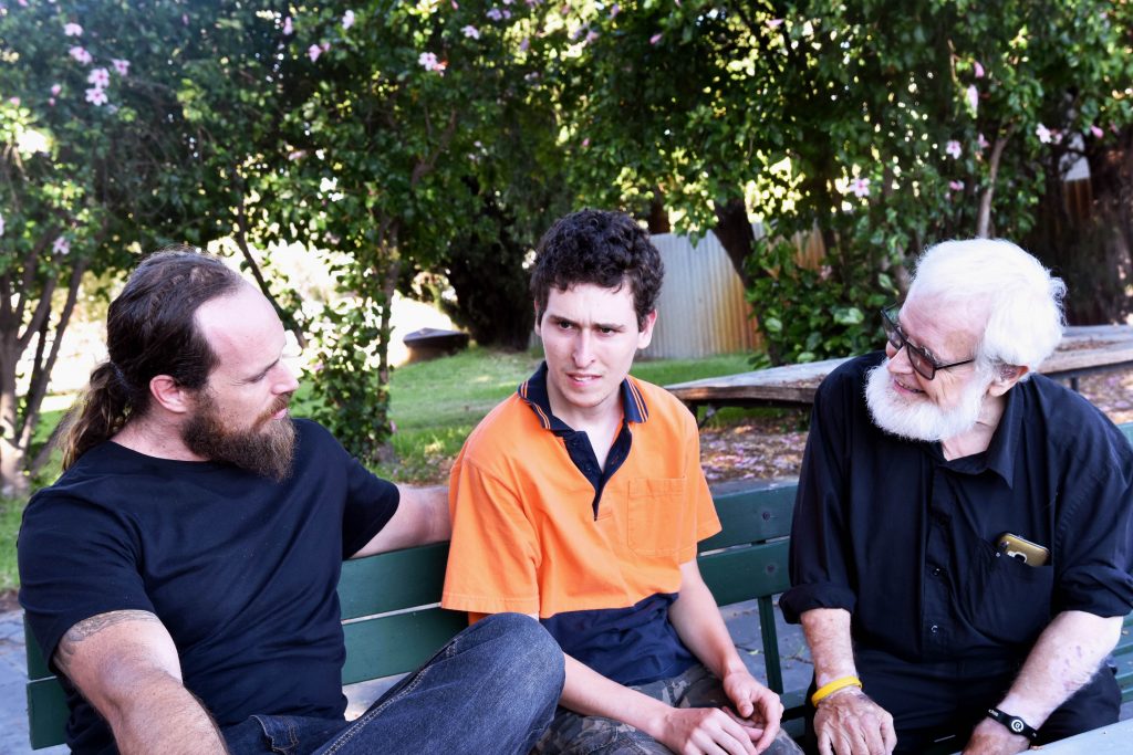 Fr Paul Pitzen having a chat with volunteers Dan and Declan (middle and far left). Photo Natashya Fernandez