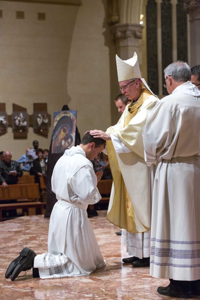 Bishop Sproxton laid hands on each of the Deacons Elect before saying the Prayer of Ordination. Photo: Ron Tan