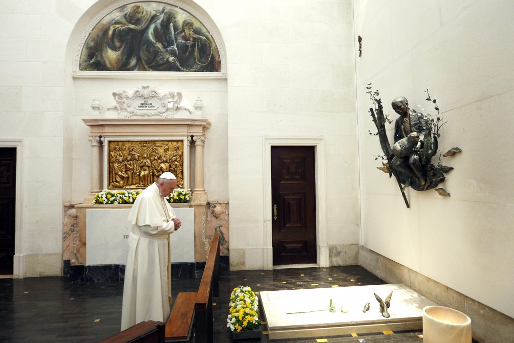 Pope Francis prays at the tomb of Fatima seer Francisco Marto before celebrating the canonisation Mass for him and his sister, Jacinta Marto, at the Shrine of Our Lady of Fatima in Portugal on the 13 May. The Mass marked the 100th anniversary of the Fatima Marian apparitions, which began on May 13, 1917. Photo: CNS/Paul Haring.