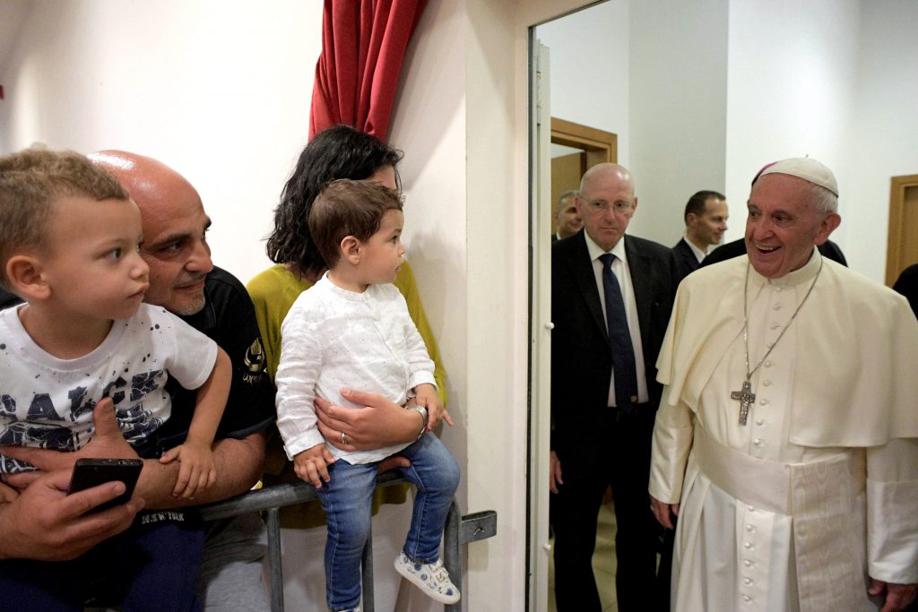 Pope Francis greets a family during his visit to the parish of San Pier Damiani May 21 at Casal Bernocchi on the outskirts of Rome. Photo: CNS photo/L'Osservatore Romano.