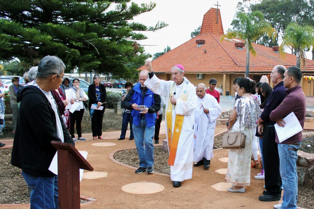 Emeritus Archbishop Barry Hickey blesses a new Rosary Garden Path at Maida Vale Parish during the annual Flores de May celebrations to commemorate the feast of Our Lady of Fatima. Photo: Supplied.