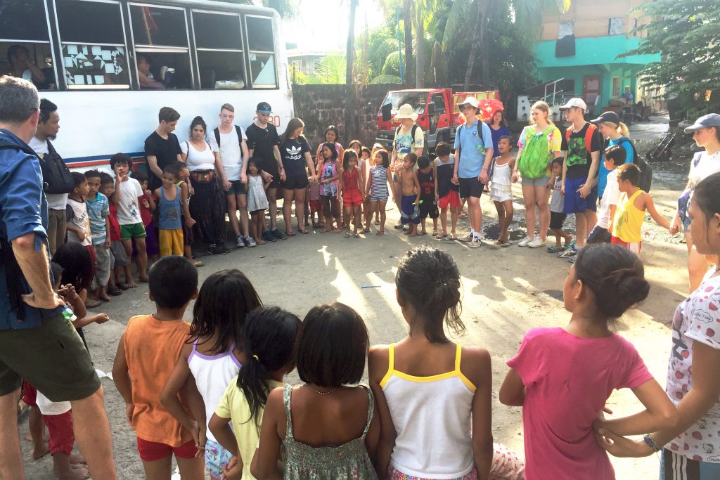 Students and teachers accompanying the social workers from KUYA Centre for street children to visit the youth and families living on the streets of Manila. Photo Supplied. 