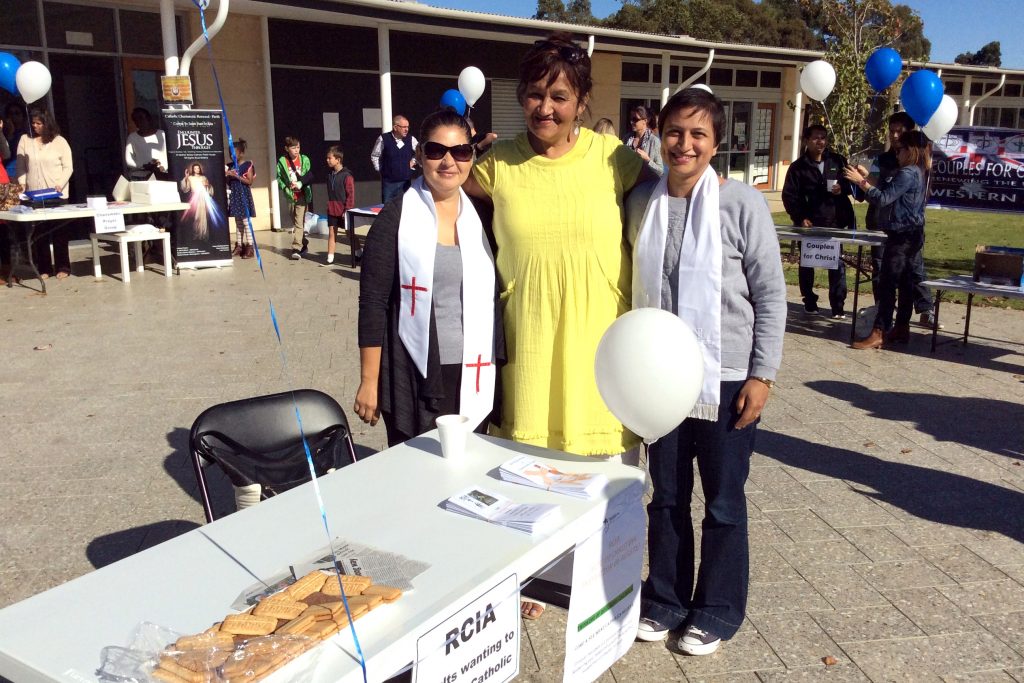 RCIA members (left and right) neophytes Meryl and Val with their sponsor Sandra (middle) at the Baldivis Parish Expo on 28 May. Photo: Supplied. 