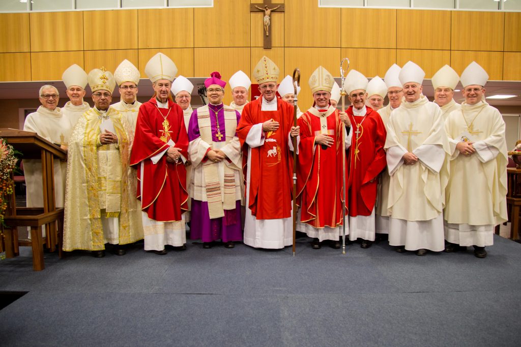 Newly ordained Bishop of Geraldton, the Most Rev Michael Morrissey (centre), with Apostolic Nuncio His Excellency Archbishop Yllana (seventh from left) Perth Archbishop Timothy Costelloe (seventh from right), Archbishop Emeritus Barry Hickey (fifth from left), Bishop Emeritus of Geraldton Justin Bianchini (fifth from right) and fellow Bishops from across Australia. Photo: Jamie O'Brien.