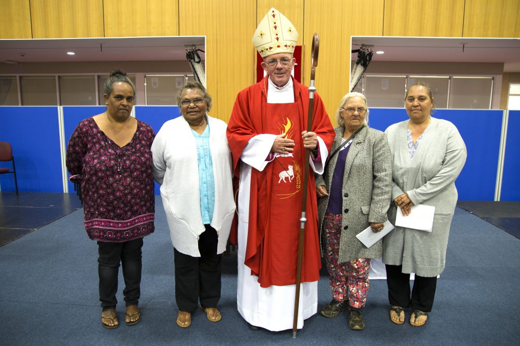 Newly ordained Bishop of Geraldton the Most Rev Michael Morrissey with local Aboriginal parishioners. Photo: Jamie O’Brien.