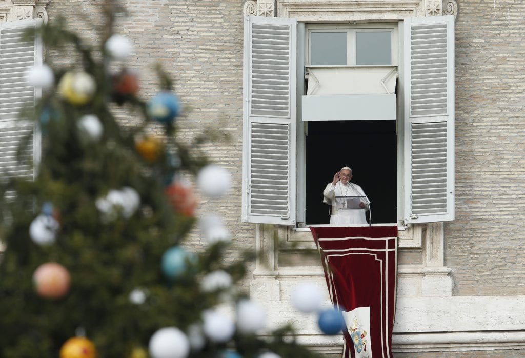 The Christmas tree is seen as Pope Francis leads the Angelus from the window of his studio overlooking St. Peter's Square at the Vatican Dec. 8, the feast of the Immaculate Conception. (CNS photo/Paul Haring) See POPE-IMMACULATE-CONCEPTION Dec. 8, 2017.