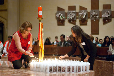 The Faith Centre’s Chris Jaques and Lydia Stanley, above, light up the evening’s Year of Grace candles. 