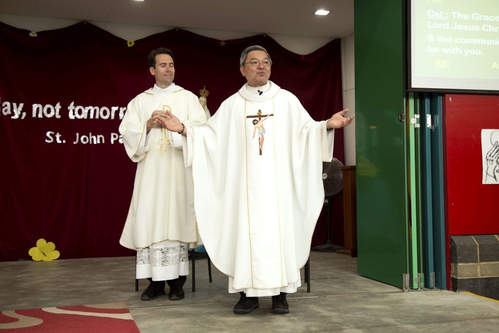 Banksia Grove Parish Priest Fr Vinh Dong and Deacon Joseph Laundy greet parishioners at the Mass celebrating the feast day of St John Paul II on 22 October, focused on the theme, ‘The future starts today and not tomorrow.’ Photo: Jamie O’Brien.