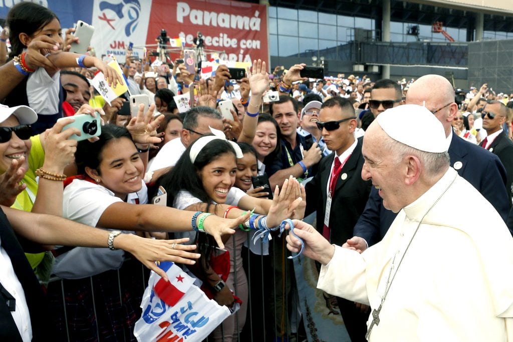 Pope Francis holds a bracelet given by a young person as he arrives at Tocumen International Airport in Panama City on 23 January 2019. Photo: CNS/Paul Haring.