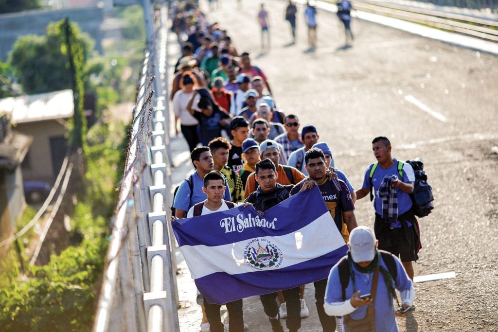A group of Salvadoran migrants, part of a caravan traveling to the United States, walks along a road on 2 November in Tecun Uman, Guatemala. Photo: CNS/Ueslei Marcelino, Reuters.