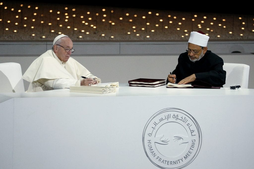 Pope Francis and Sheik Ahmad el-Tayeb, grand imam of Egypt's al-Azhar mosque and university, sign documents during an interreligious meeting at the Founder's Memorial in Abu Dhabi, United Arab Emirates on 4 February 2019. The Holy Father and Sheik el-Tayeb stepped into a theological debate on the will of God toward religions when they signed a document on "human fraternity" and improving Christian-Muslim relations. Photo: Paul Haring/CNS.