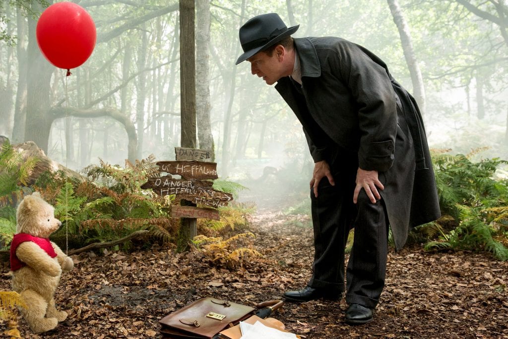 Ewan McGregor, as Christopher Robin, shares a scene with Winnie the Pooh in the live-action adventure movie "Christopher Robin". Photo: Laurie Sparham/Disney.