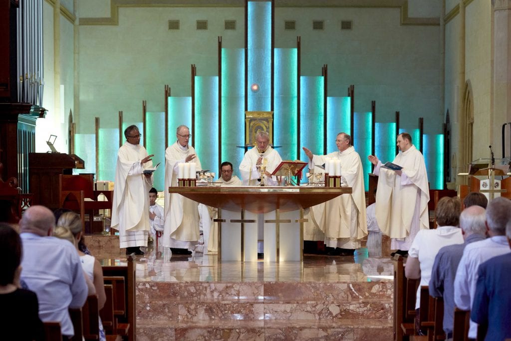 Fr Sean Fernandez, Bishop Donald Sproxton, Archbishop Timothy Costelloe SDB, Vicar General Fr Peter Whitely, and Fr CJ Millen consecrate the Blessed Sacrament on 1 February. Photo: Ron Tan.