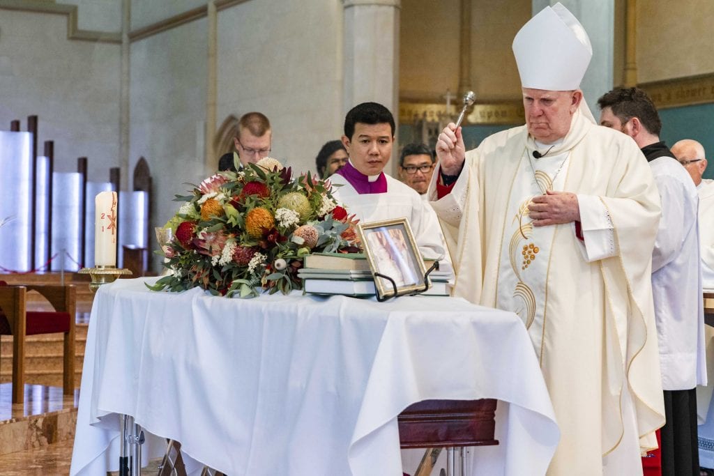 Bunbury Bishop Gerard Holohan blesses the coffin of Rev Dr Russell Hardiman during the Funeral Mass on Tuesday 29 January 2019 at St Mary’s Cathedral. Photo: Jamie O’Brien.