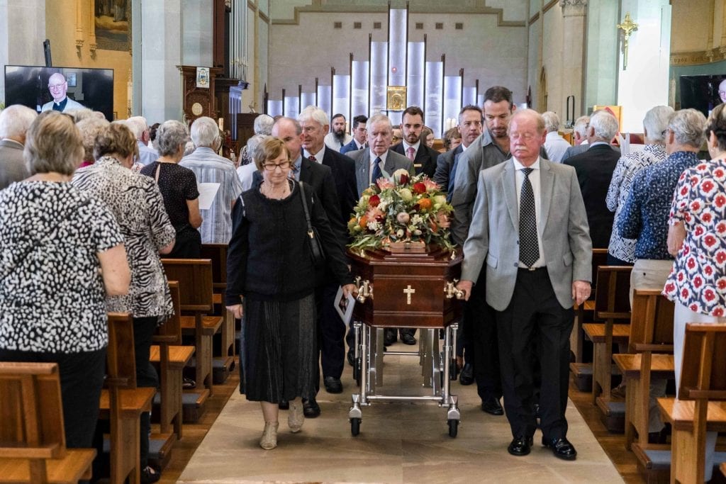 Family and friends of Rev Dr Russell Hardiman escort the coffin during the Funeral Mass on Tuesday 29 January 2019 at St Mary’s Cathedral. Photo: Jamie O’Brien.
