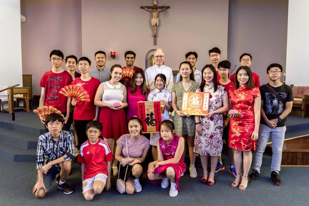 Auxiliary Bishop Donald Sproxton pictured after Mass with members of the SPX Youth Manning group. Photo: Matthew Lau.