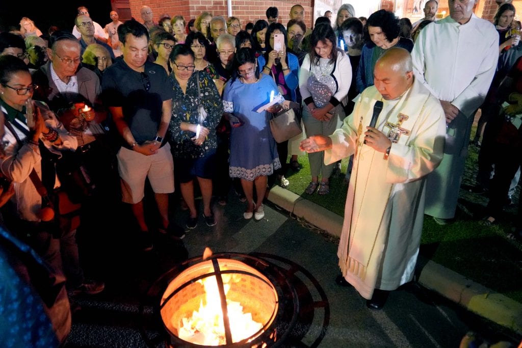 Greenwood Parish Priest Fr Elver Delicano burns the faithful’s petitions to bring the 10-day novena to a finish. Photo: Matthew Lau.