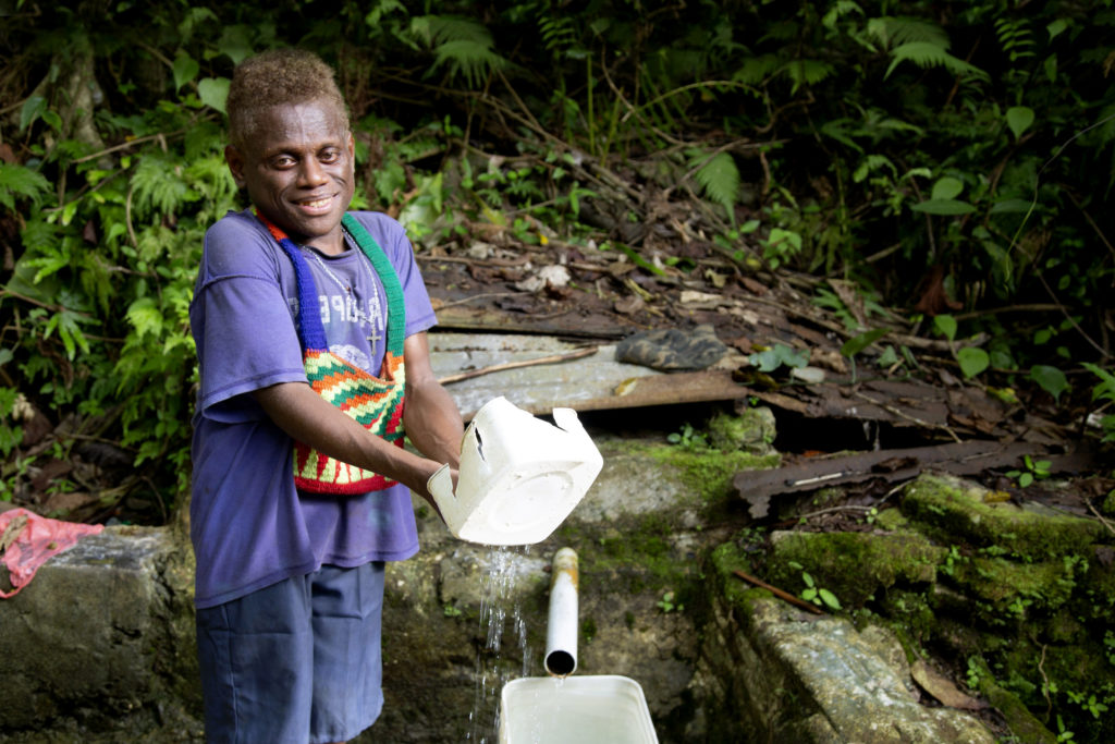 Peter bathes with water from a well about a kilometre away from his boarding school on Malaita Island, in the Solomon Islands. Photo: Cassandra Hill/Caritas Australia.