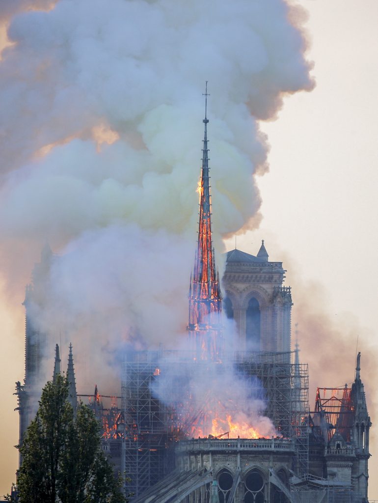 Flames and smoke billow from the Notre Dame Cathedral after a fire broke out in Paris on 15 April 2019. Officials said the cause was not clear, but that the fire could be linked to renovation work. Photo: Charles Platiau/Reuters.