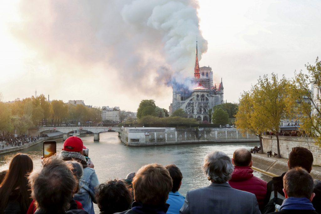 Flames and smoke billow from the Notre Dame Cathedral after a fire broke out in Paris on 15 April 2019. Officials said the cause was not clear, but that the fire could be linked to renovation work. Photo: Benoit Tessier/Reuters.